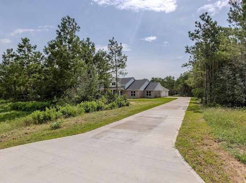 Front exterior of a new home in , Willis, TX, highlighting curb appeal (Image 26). Front exterior of a new home in , Willis, TX, highlighting curb appeal (Image 26).
