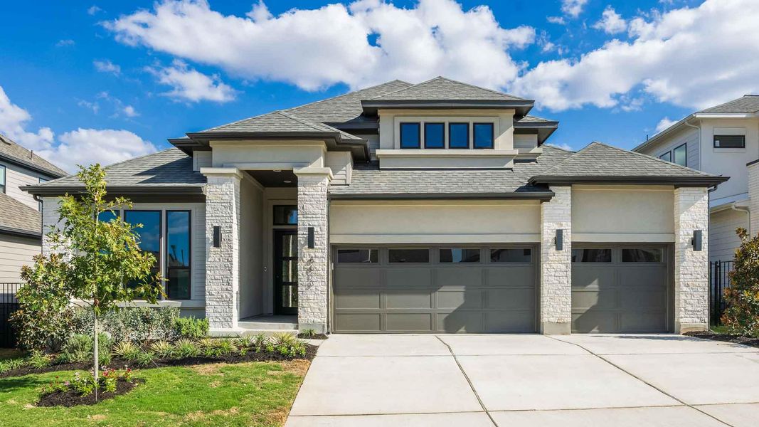 Prairie-style home with a shingled roof, concrete driveway, stone siding, and stucco siding Prairie-style home with a shingled roof, concrete driveway, stone siding, and stucco siding