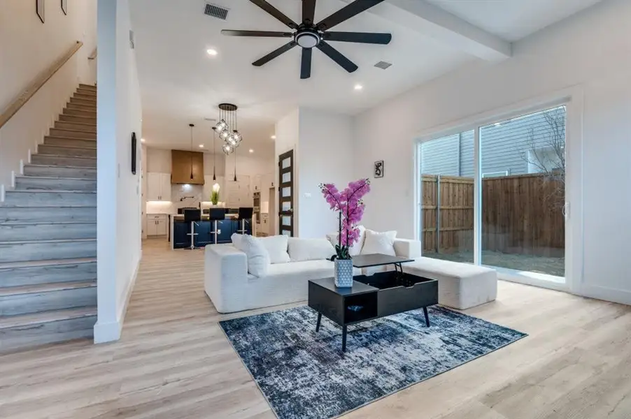 Spacious first-floor living room opening to the backyard, flowing effortlessly into the gourmet kitchen and adjacent wine room, creating a luxurious space for entertaining and relaxing. Spacious first-floor living room opening to the backyard, flowing effortlessly into the gourmet kitchen and adjacent wine room, creating a luxurious space for entertaining and relaxing.