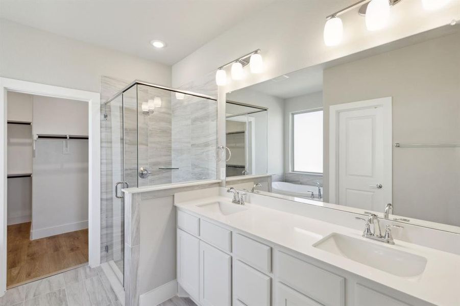 Bathroom with vanity and a shower with shower door