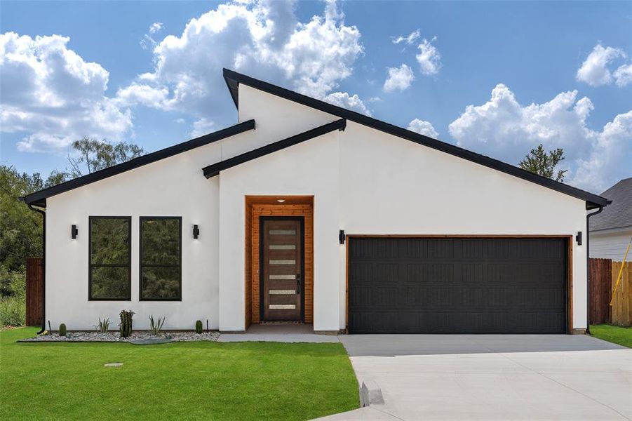 Modern home with a garage and a front lawn