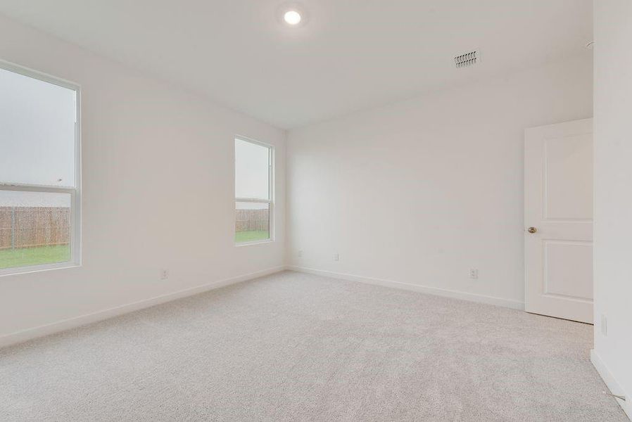 Empty room with light colored carpet and recessed lighting Empty room with light colored carpet and recessed lighting