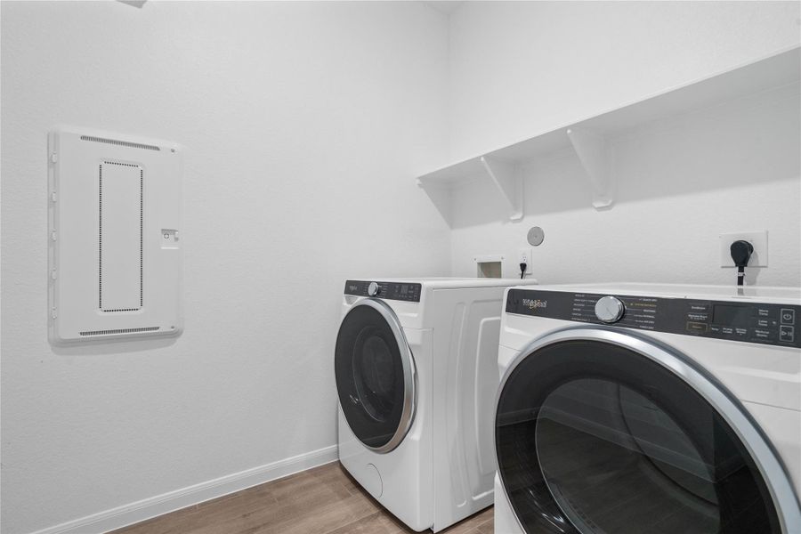 This dedicated laundry room comes equipped with a washer and dryer set, ready for immediate use.