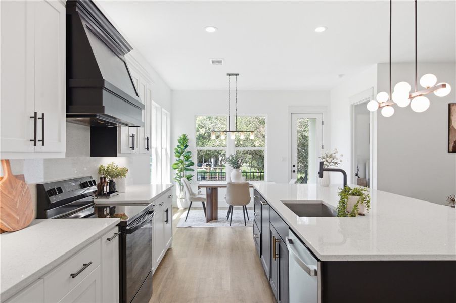A contemporary kitchen features an inviting island, crisp white countertops, and sleek, modern fixtures. A contemporary kitchen features an inviting island, crisp white countertops, and sleek, modern fixtures.