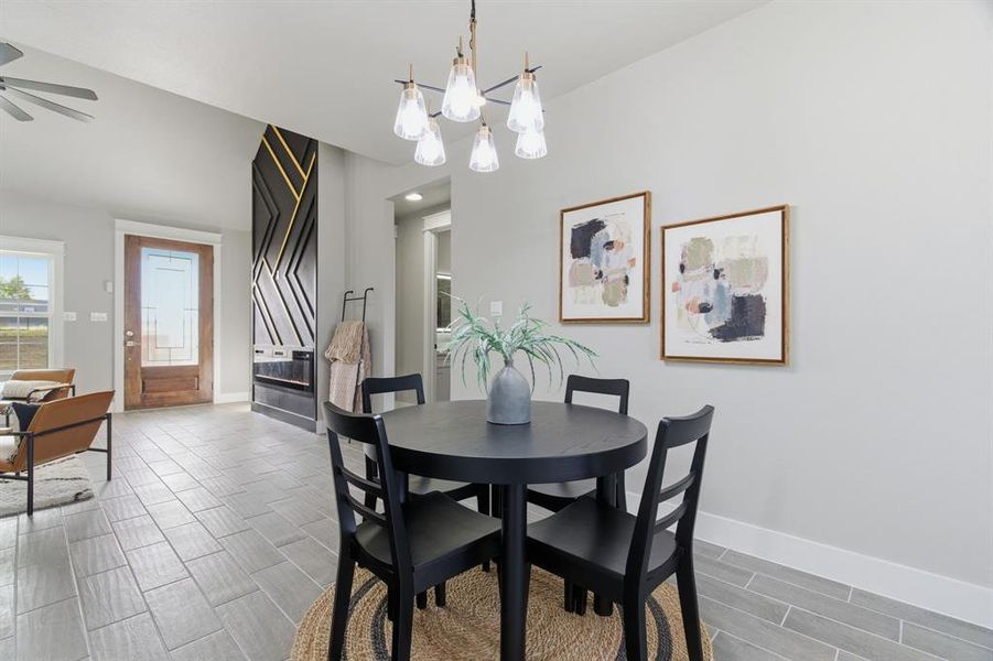 Dining room with wood finish floors and a chandelier
