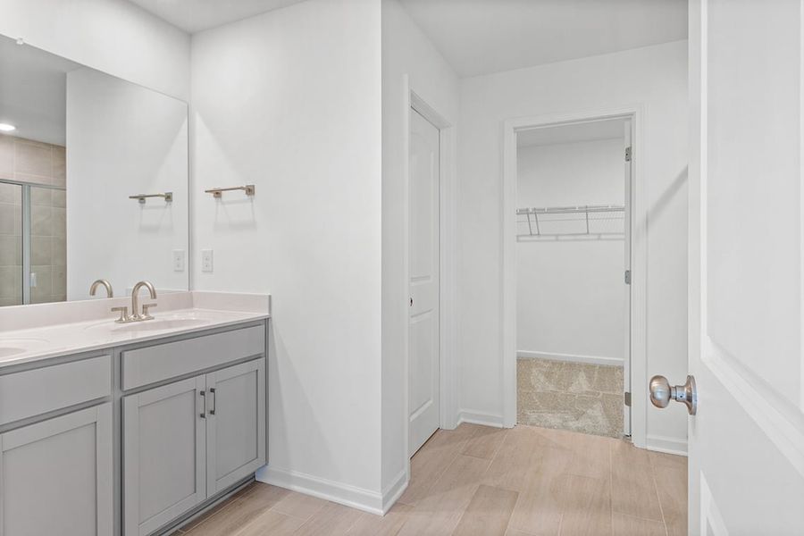A bathroom with white cabinets.