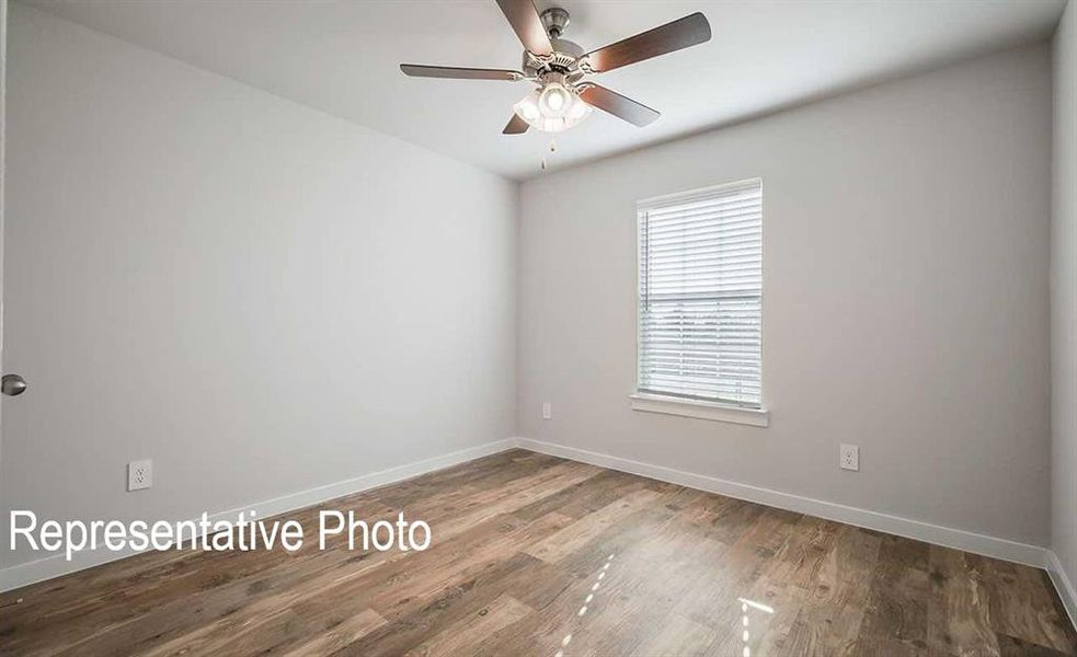 Unfurnished room with wood-type flooring and ceiling fan