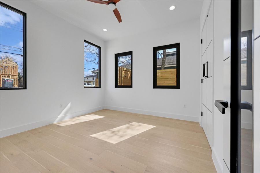 Spare room with ceiling fan, light wood-style floors, and recessed lighting