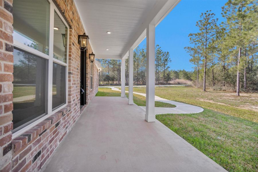 This beautiful brick home welcomes you with an expansive front patio designed for both relaxing and entertaining. The oversized front door creates a grand entrance and sets the tone for the impressive interior that awaits. From the moment you step onto the spacious patio, you’ll appreciate the inviting curb appeal and thoughtful design.