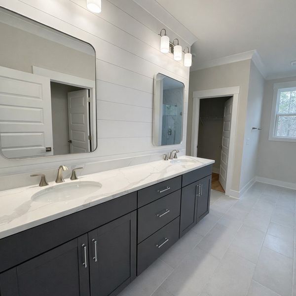 This spacious bathroom offers a double vanity with