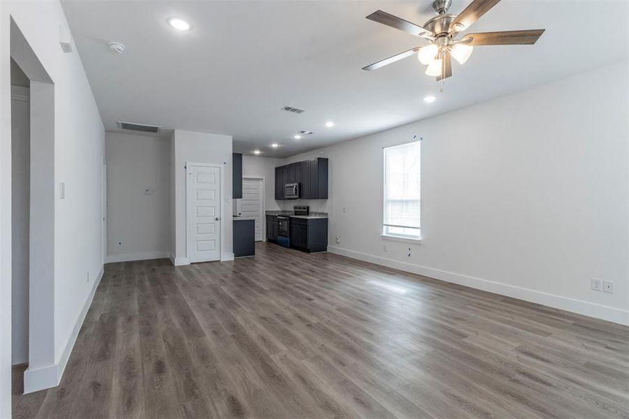 Unfurnished living room with hardwood / wood-style floors and ceiling fan