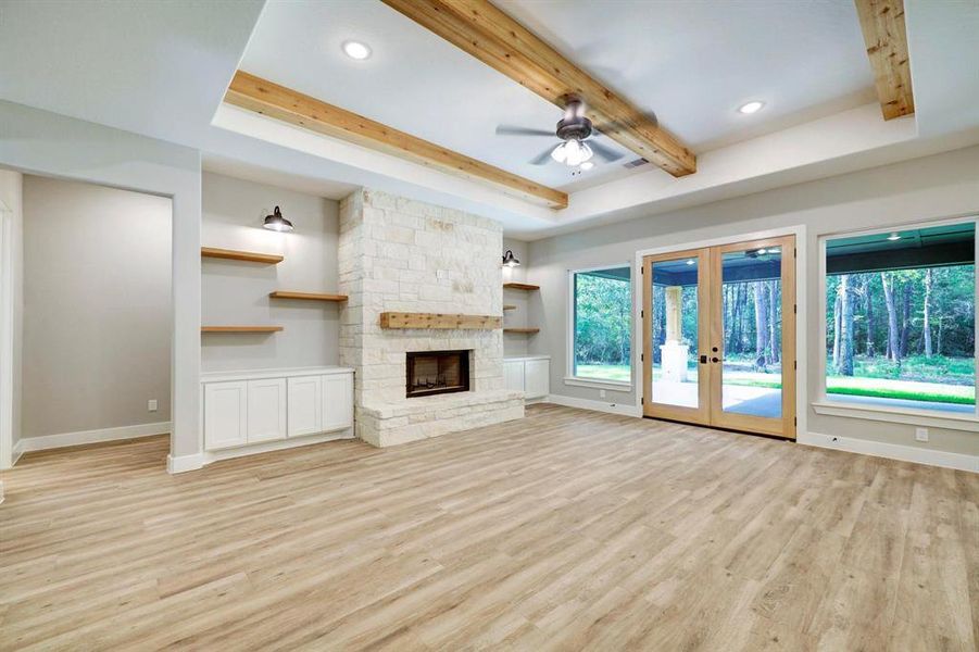 This stylish living room offers a fantastic ambiance, bathed in natural light from a stunning wall of windows.