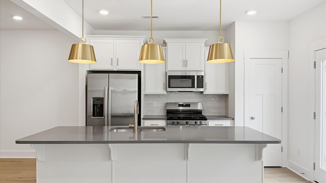 Well-designed kitchen with a center island and tasteful finishes that elevate everyday living near Downtown Greenville, SC Well-designed kitchen with a center island and tasteful finishes that elevate everyday living near Downtown Greenville, SC