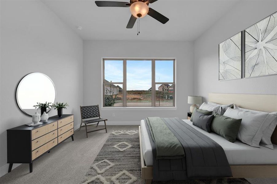 Carpeted bedroom with a ceiling fan and baseboards Carpeted bedroom with a ceiling fan and baseboards