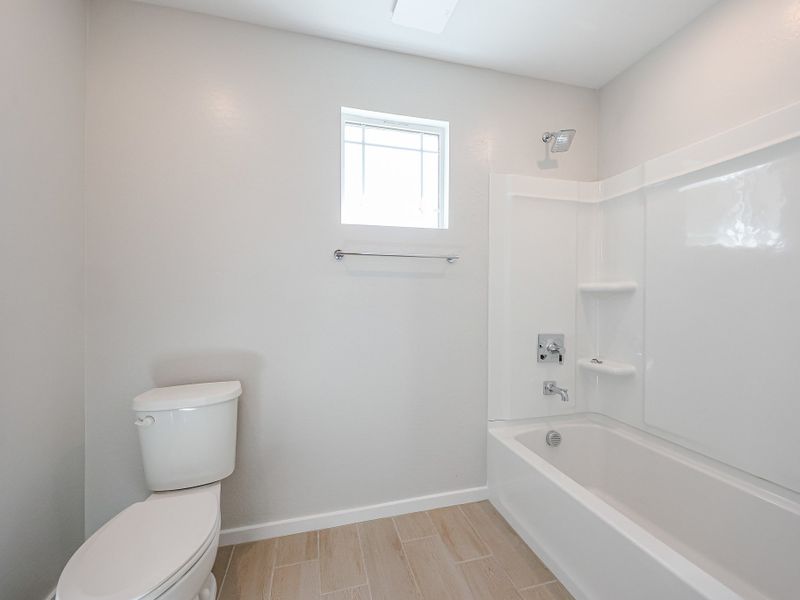 A bathroom with a tub toilet and sink. A bathroom with a tub toilet and sink.