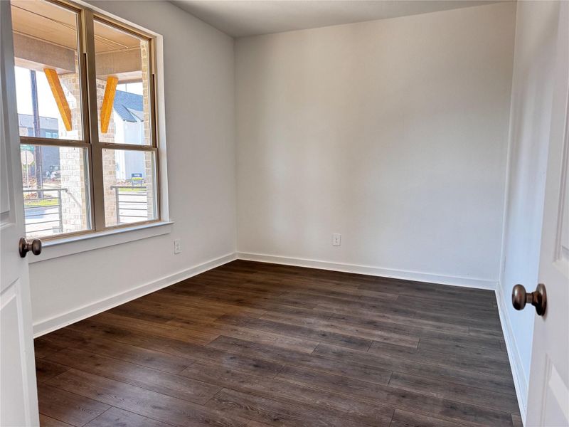 Cozy study space with front-facing windows and porch views. Cozy study space with front-facing windows and porch views.