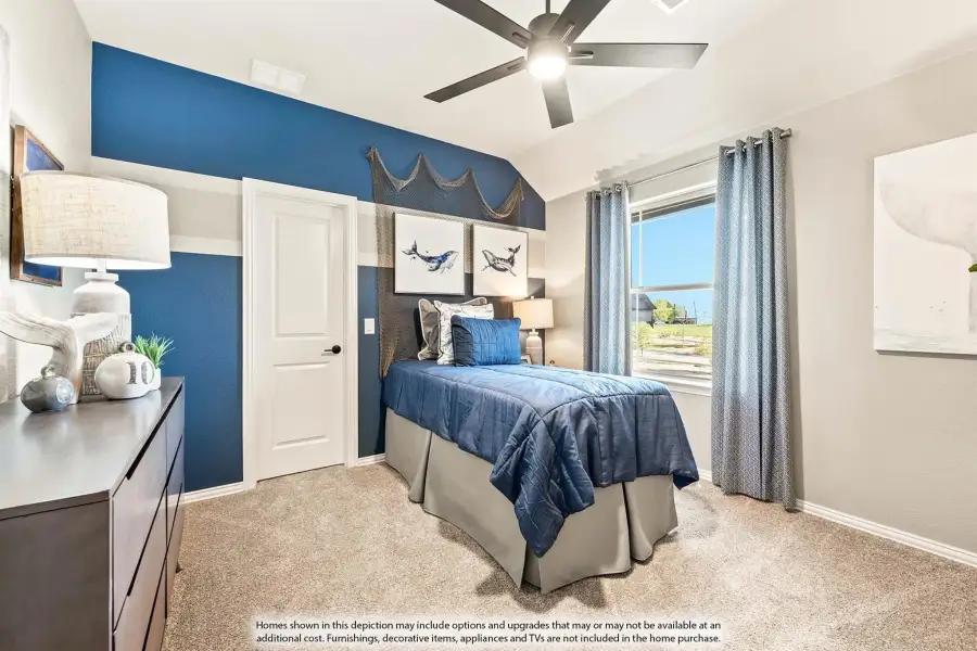 Bedroom with blue accent wall, vaulted ceiling, ceiling fan, and carpeted floor