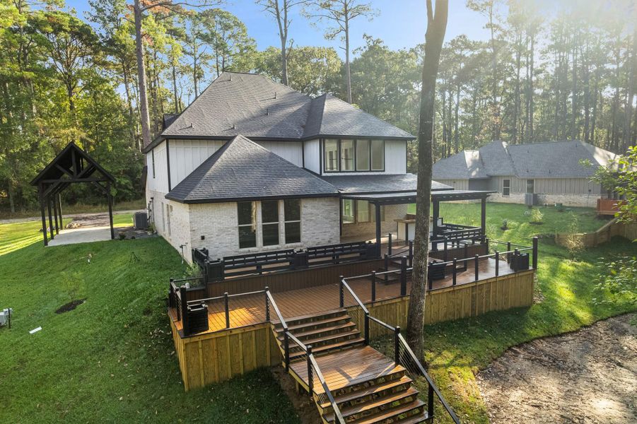 This stunning two-story home features a modern design with a spacious Trex deck and outdoor seating area, perfect for entertaining. It’s nestled in a serene wooded setting, offering privacy and a natural backdrop. The property includes a wide driveway and a separate covered structure, ideal for extra parking or storage. This stunning two-story home features a modern design with a spacious Trex deck and outdoor seating area, perfect for entertaining. It’s nestled in a serene wooded setting, offering privacy and a natural backdrop. The property includes a wide driveway and a separate covered structure, ideal for extra parking or storage.