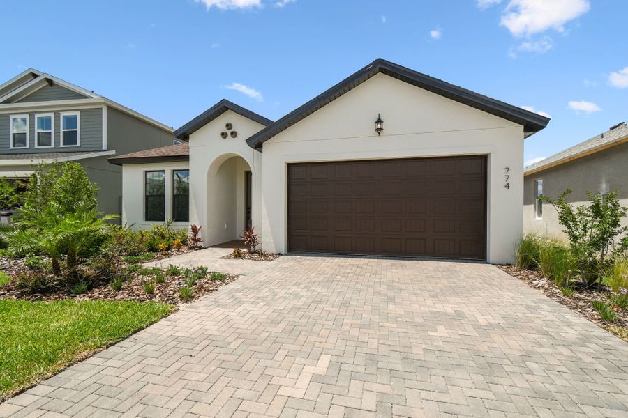 Front exterior of a new home in Avalon West, Spring Hill, FL, highlighting curb appeal (Image 5).