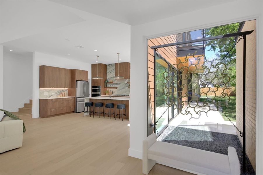 Entryway featuring wood finished floors and recessed lighting and custom design metal artwork