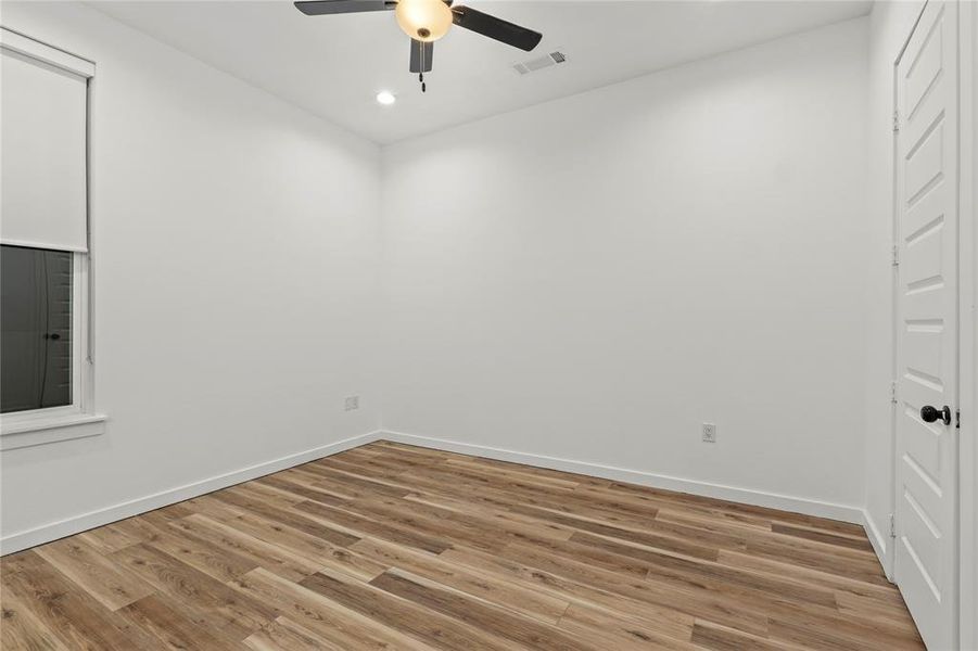Unfurnished room featuring ceiling fan, light wood-style floors, and recessed lighting Unfurnished room featuring ceiling fan, light wood-style floors, and recessed lighting