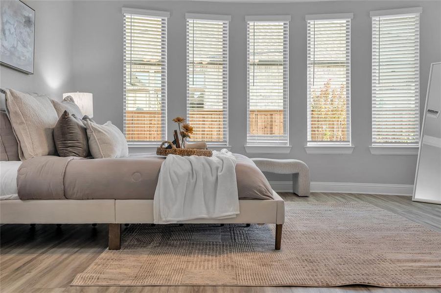 Bedroom with light wood-style floors and baseboards Bedroom with light wood-style floors and baseboards