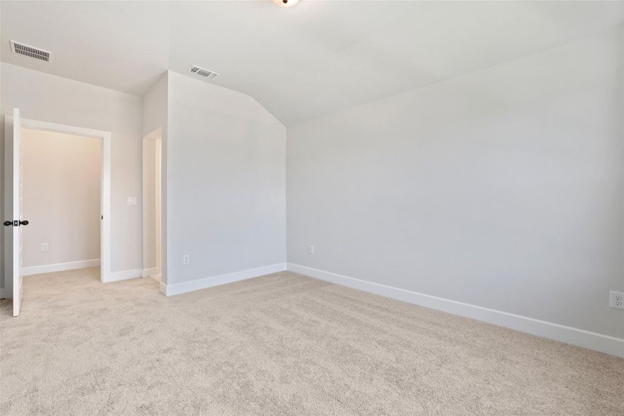Additional living space with light colored carpet and lofted ceiling Additional living space with light colored carpet and lofted ceiling