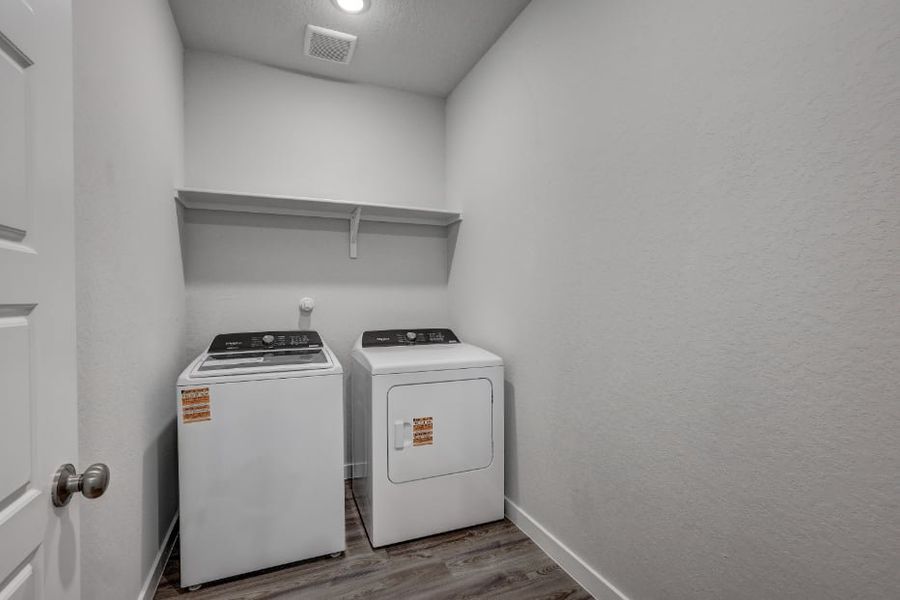 A small kitchen with a washer and dryer.
