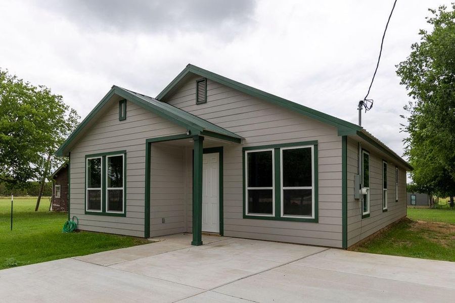 Front exterior of a new home in , Walnut Springs, TX, highlighting curb appeal (Image 21).