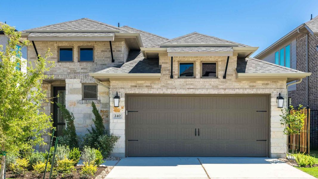 View of front of house with roof with shingles, driveway, and stone siding View of front of house with roof with shingles, driveway, and stone siding