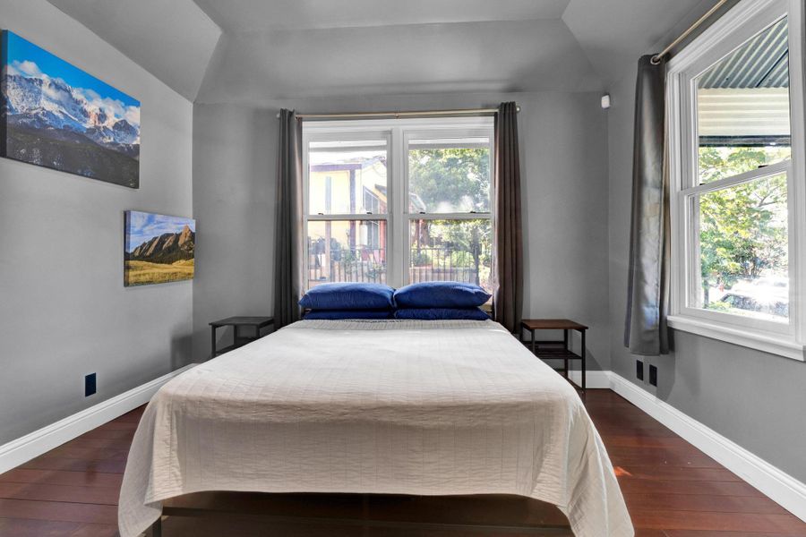 Bedroom featuring vaulted ceiling and dark wood finished floors