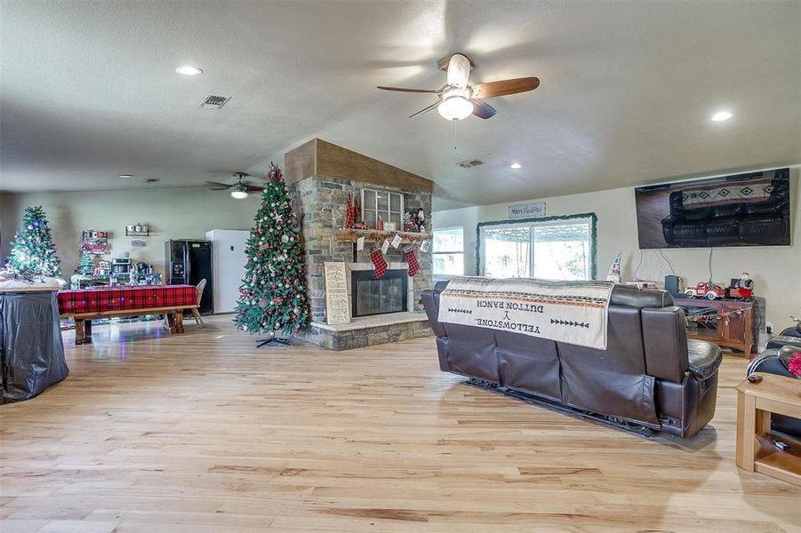 Living room with floor-to-ceiling, stone fireplace.