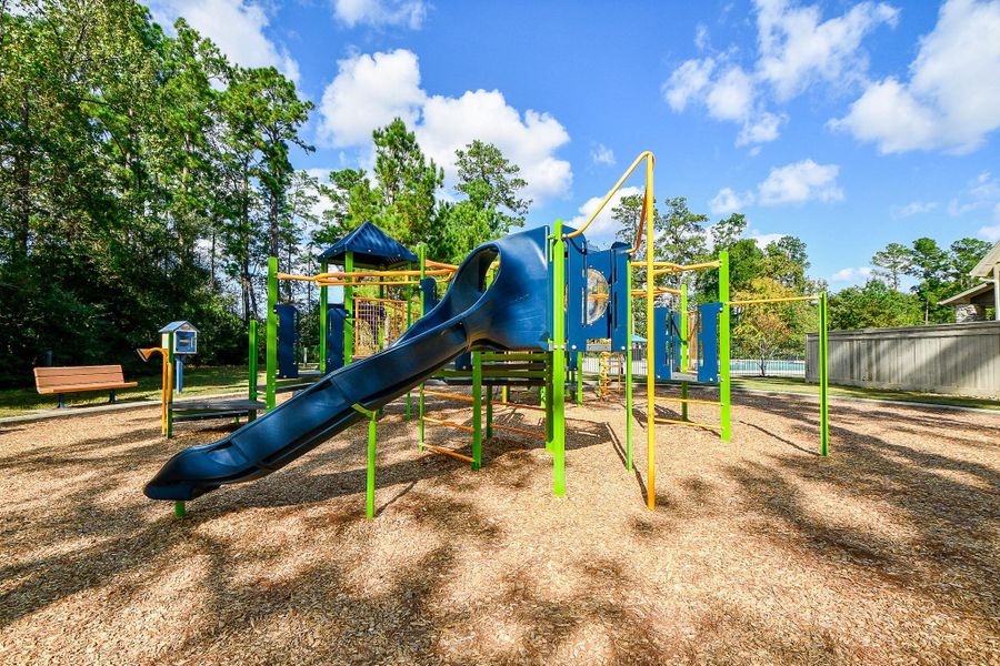 A vibrant playground featuring a slide and climbing structures, surrounded by trees and conveniently located near a dog park. Perfect for families, it provides a safe and enjoyable environment for children to play and socialize. A vibrant playground featuring a slide and climbing structures, surrounded by trees and conveniently located near a dog park. Perfect for families, it provides a safe and enjoyable environment for children to play and socialize.