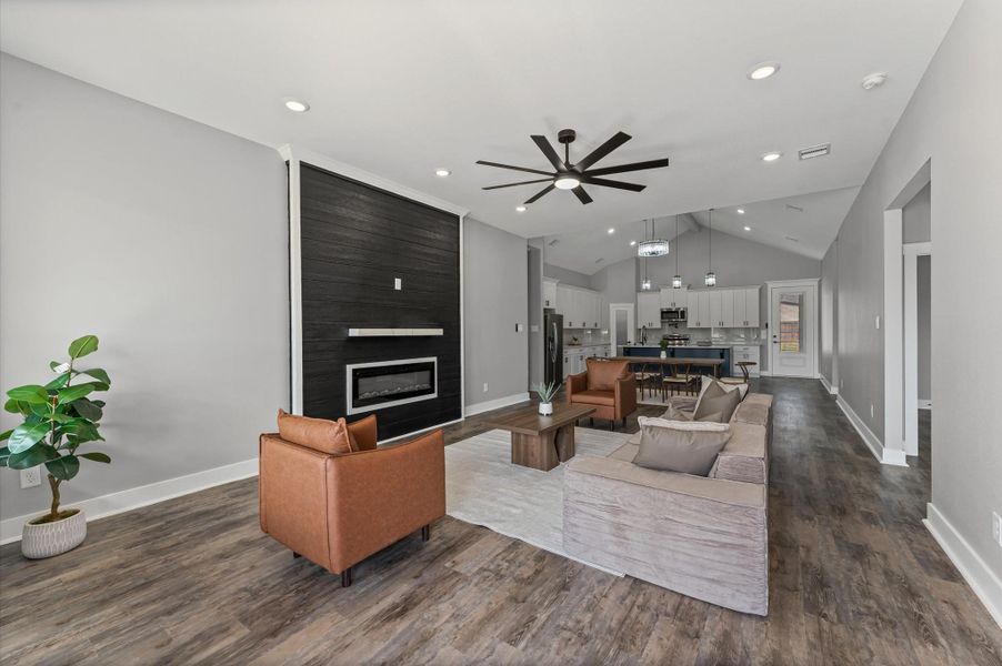 Expansive living room with a custom chimney as the focal point, surrounded by elegant finishes. Expansive living room with a custom chimney as the focal point, surrounded by elegant finishes.