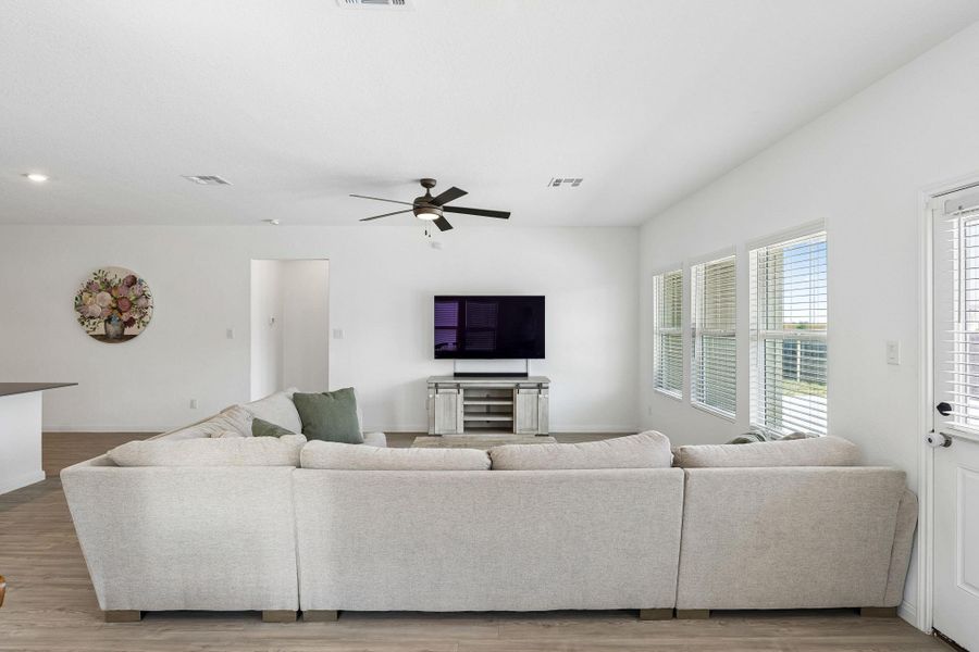 The living room offers generous proportions with hard surface flooring and abundant natural light.