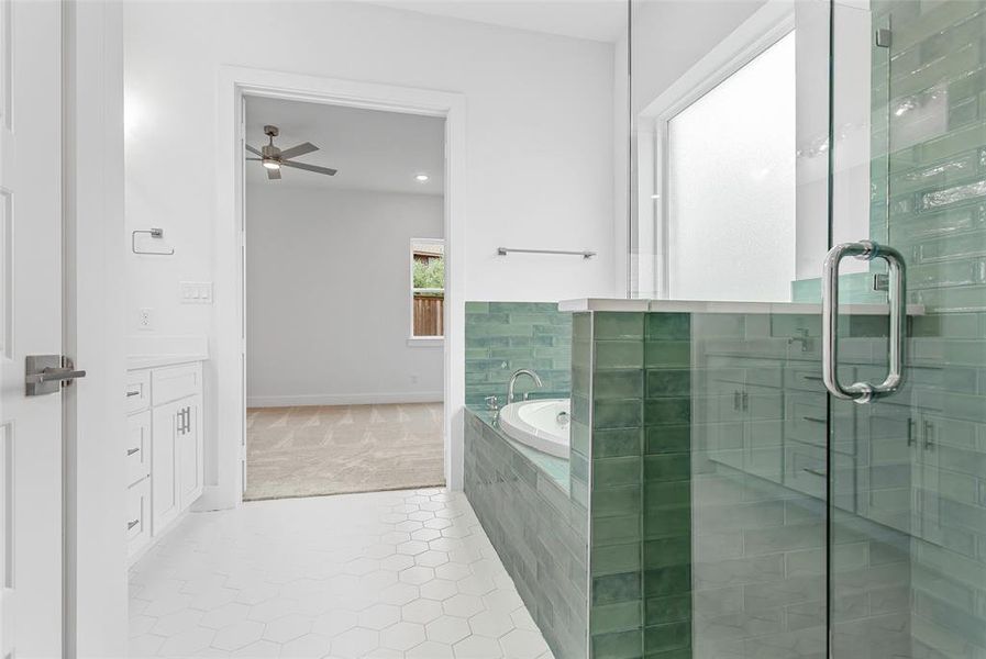 Bathroom with plus walk in shower, tile patterned floors, vanity, and ceiling fan