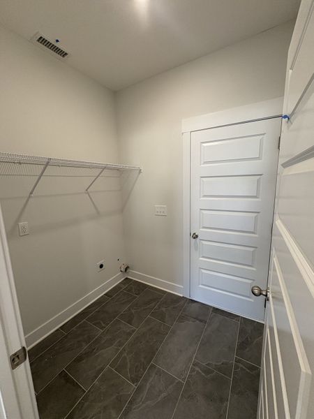 Laundry room. Door goes out to 2 car garage. Laundry room. Door goes out to 2 car garage.