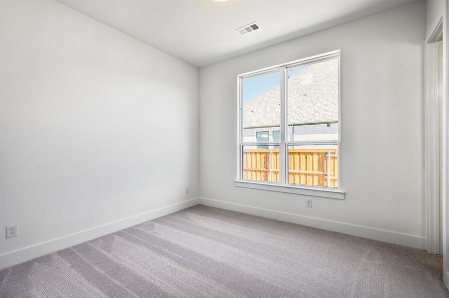 Empty room with carpet and baseboards