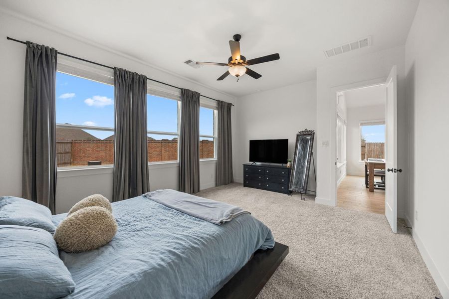 Generous square footage in the primary suite allows for larger furnishings, while the neutral color palette provides flexibility for a variety of design styles.