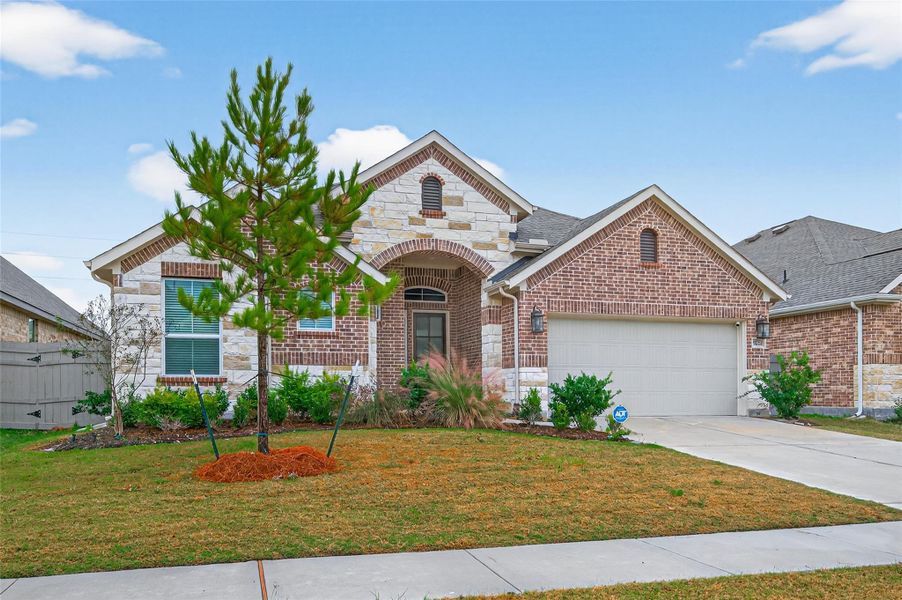 Front exterior of a new home in Artavia, Conroe, TX, highlighting curb appeal (Image 24).