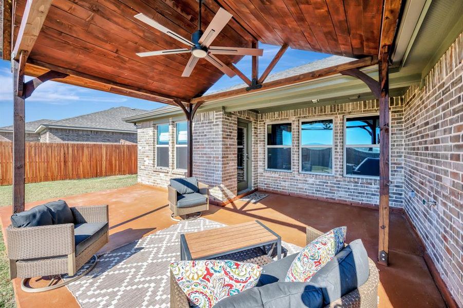 View of patio with ceiling fan and an outdoor living space