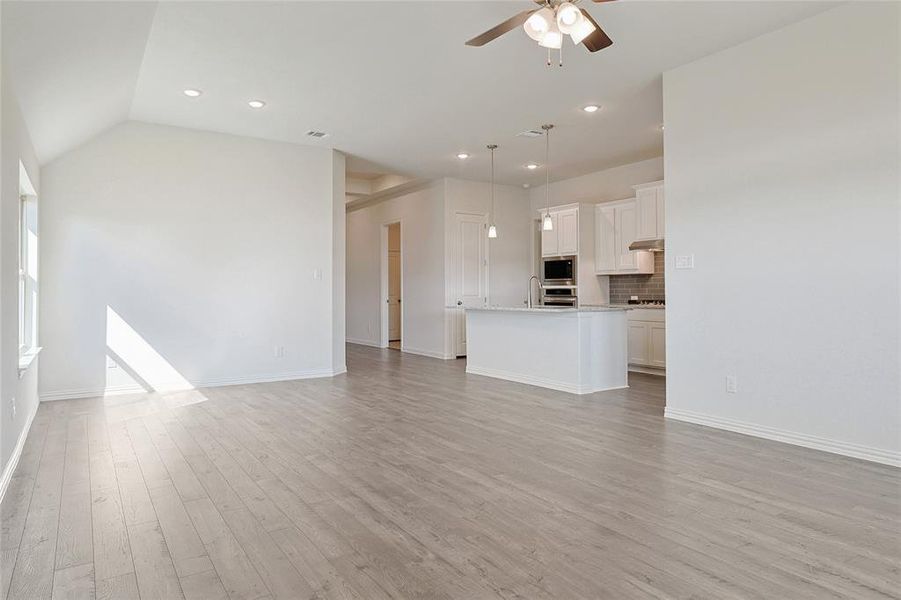 Unfurnished living room with a ceiling fan, light wood-style floors, and recessed lighting