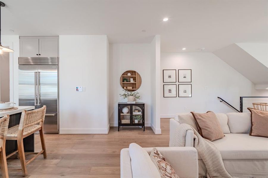 Living area featuring recessed lighting and light wood-style flooring