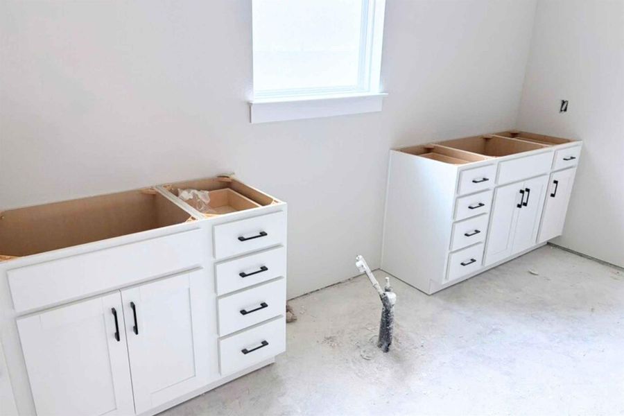 Bathroom with vanity and unfinished concrete floors