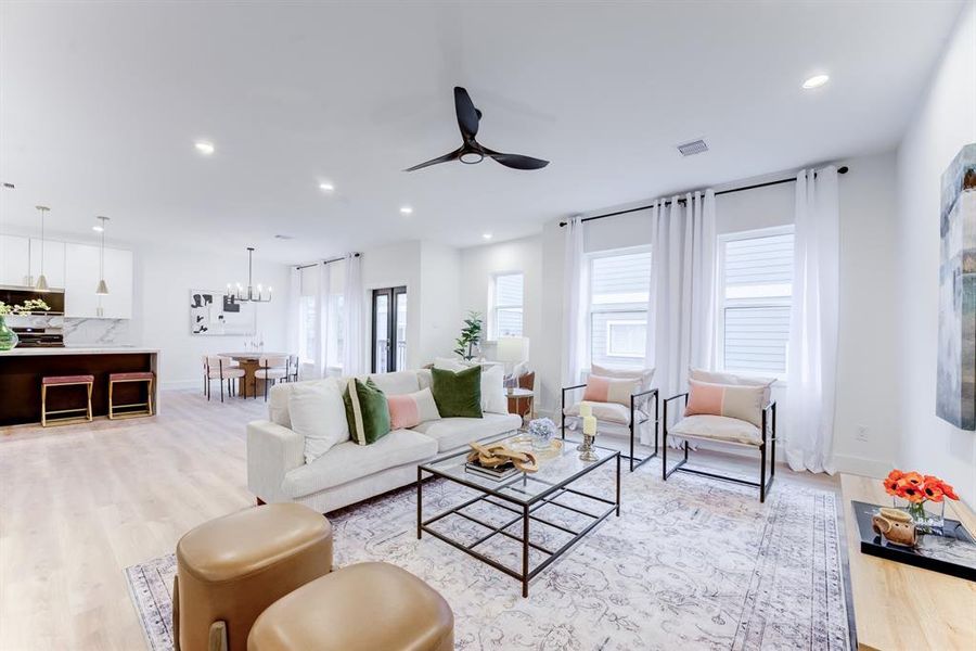 The spacious living room is open to the kitchen and has plenty of natural lighting from the windows. There is also recessed lighting.