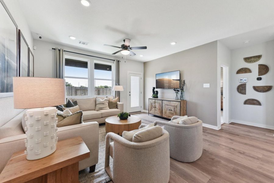 Living room featuring a ceiling fan, light wood-style flooring, and recessed lighting