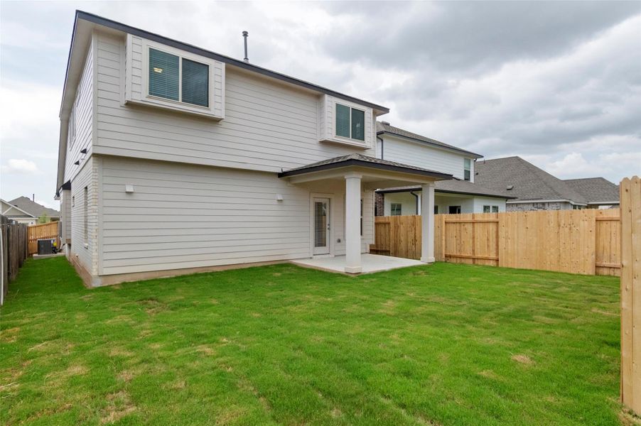 Rear view of property with a patio area and a fenced backyard Rear view of property with a patio area and a fenced backyard