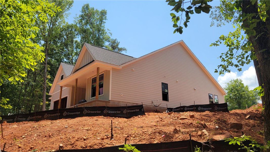 A new construction home, with light-colored siding A new construction home, with light-colored siding