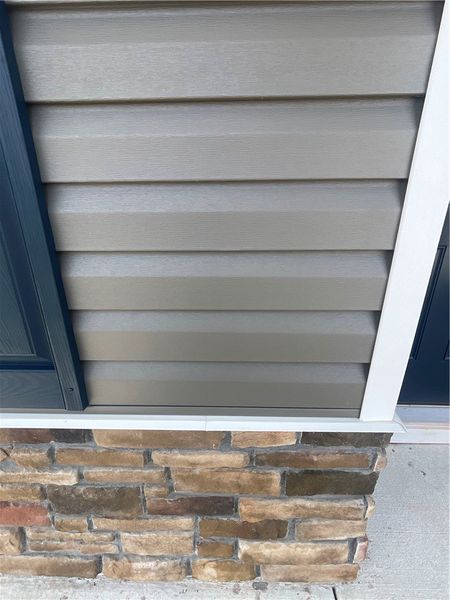Exterior details and patio area of a home in Springwood Grove, Central (Image 18).