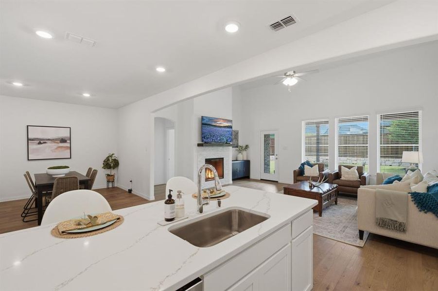 Open-concept kitchen, dining, and living layout filled with natural light and upgraded finishes. This is the modern floorplan buyers want.